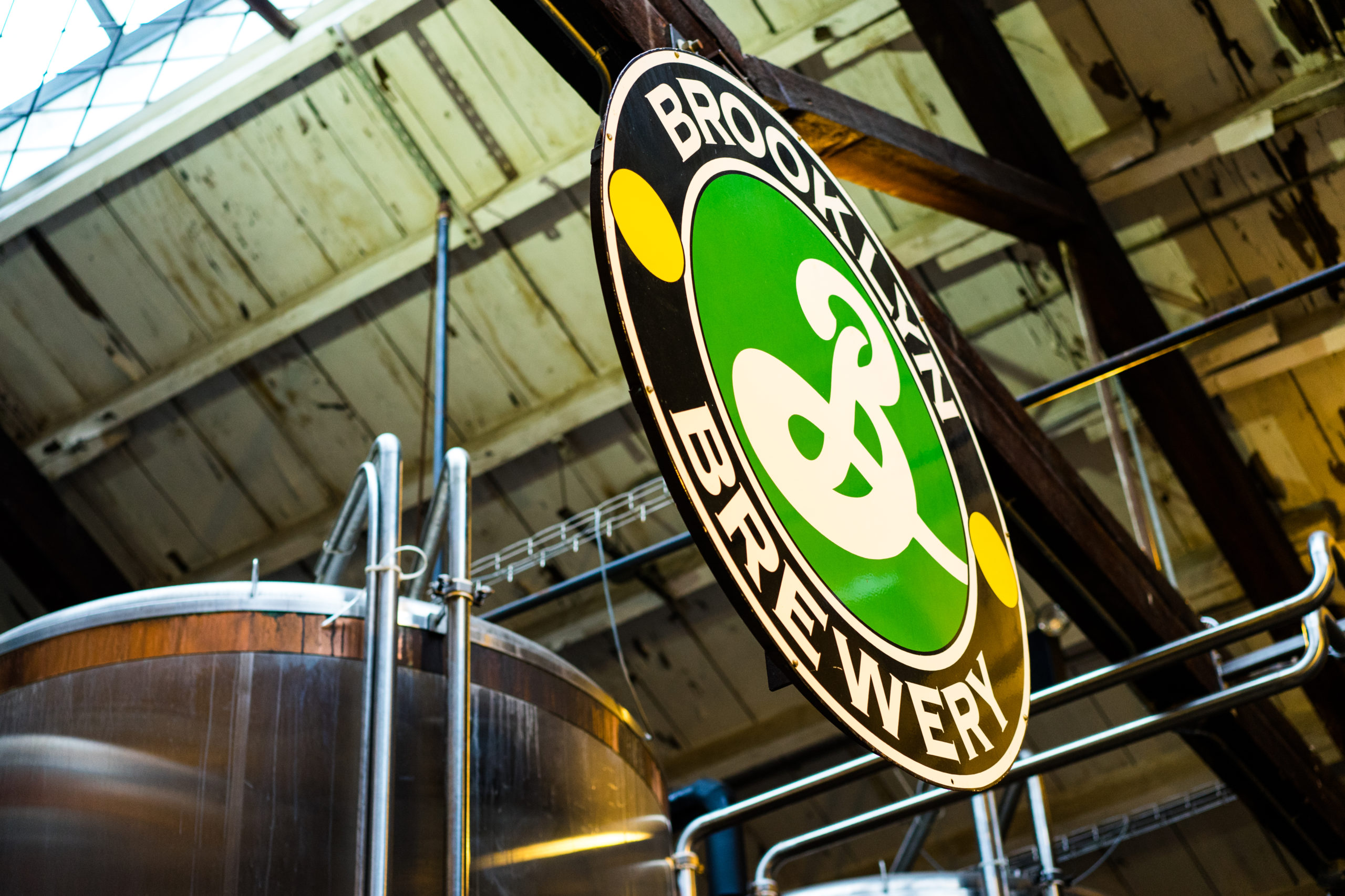 Best Williamsburg Apartments Near Breweries -Best Williamsburg Apartments Near BreweriesThe Brooklyn Brewery sign in black and green over a round brew kettle