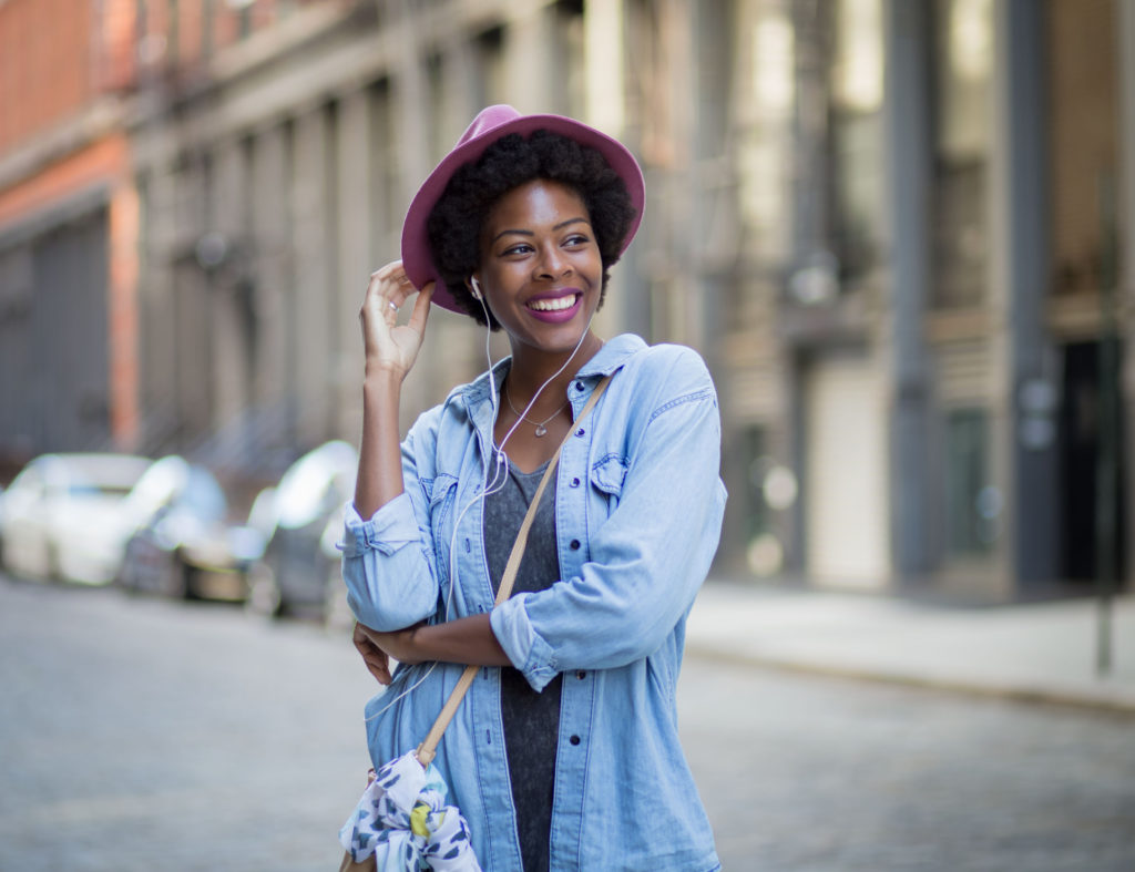 9 Great Sustainable Fashion Options in NYC - Portrait of young African American woman on city street. Photographed in Soho, NYC.