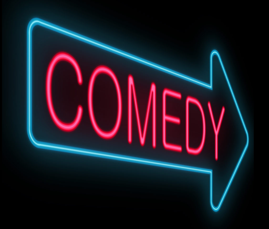 Sign: Blue Neon Arrow with Pink Neon Word: Comedy